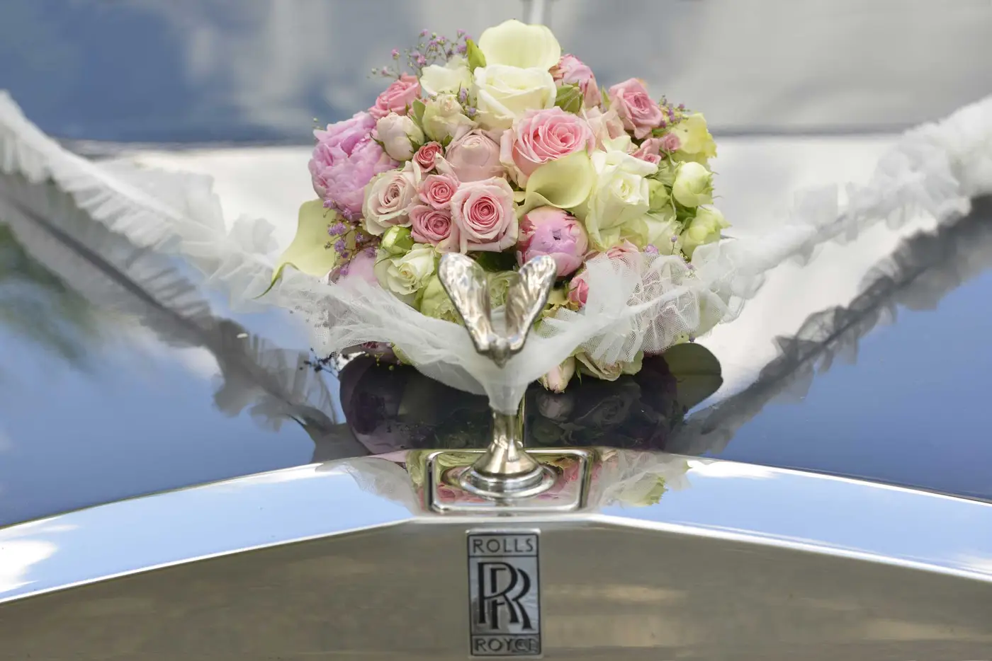 bouquet on hood of rolls